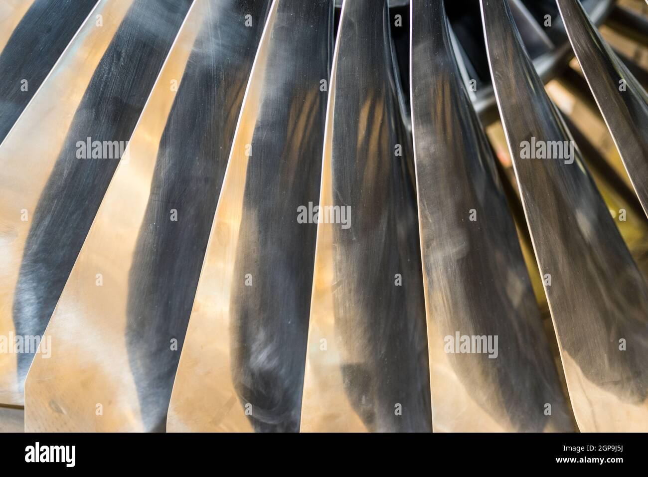 Closeup of aircraft engine fan blades with warm light Illumination