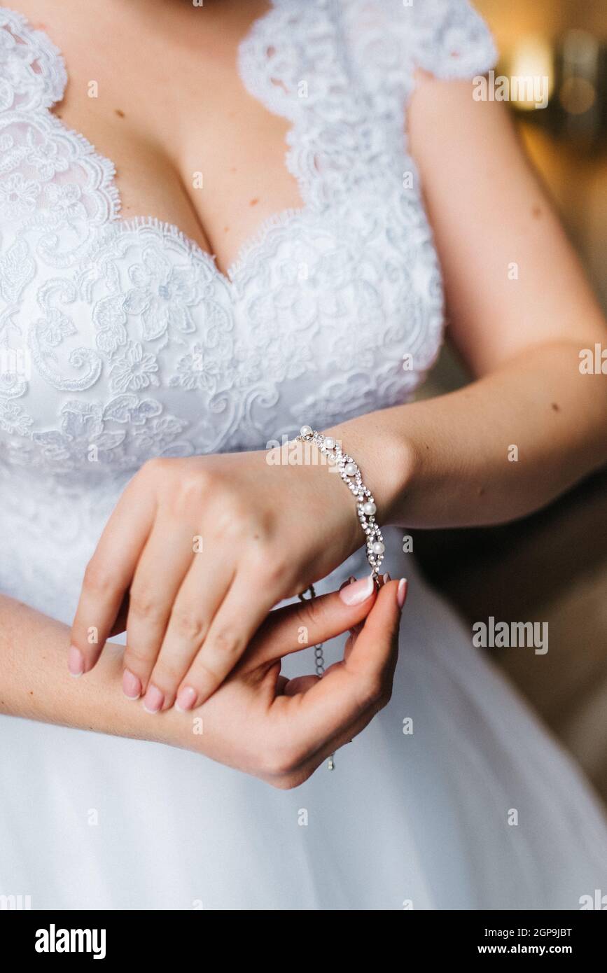 the bride wears a wedding bracelet on her left hand Stock Photo