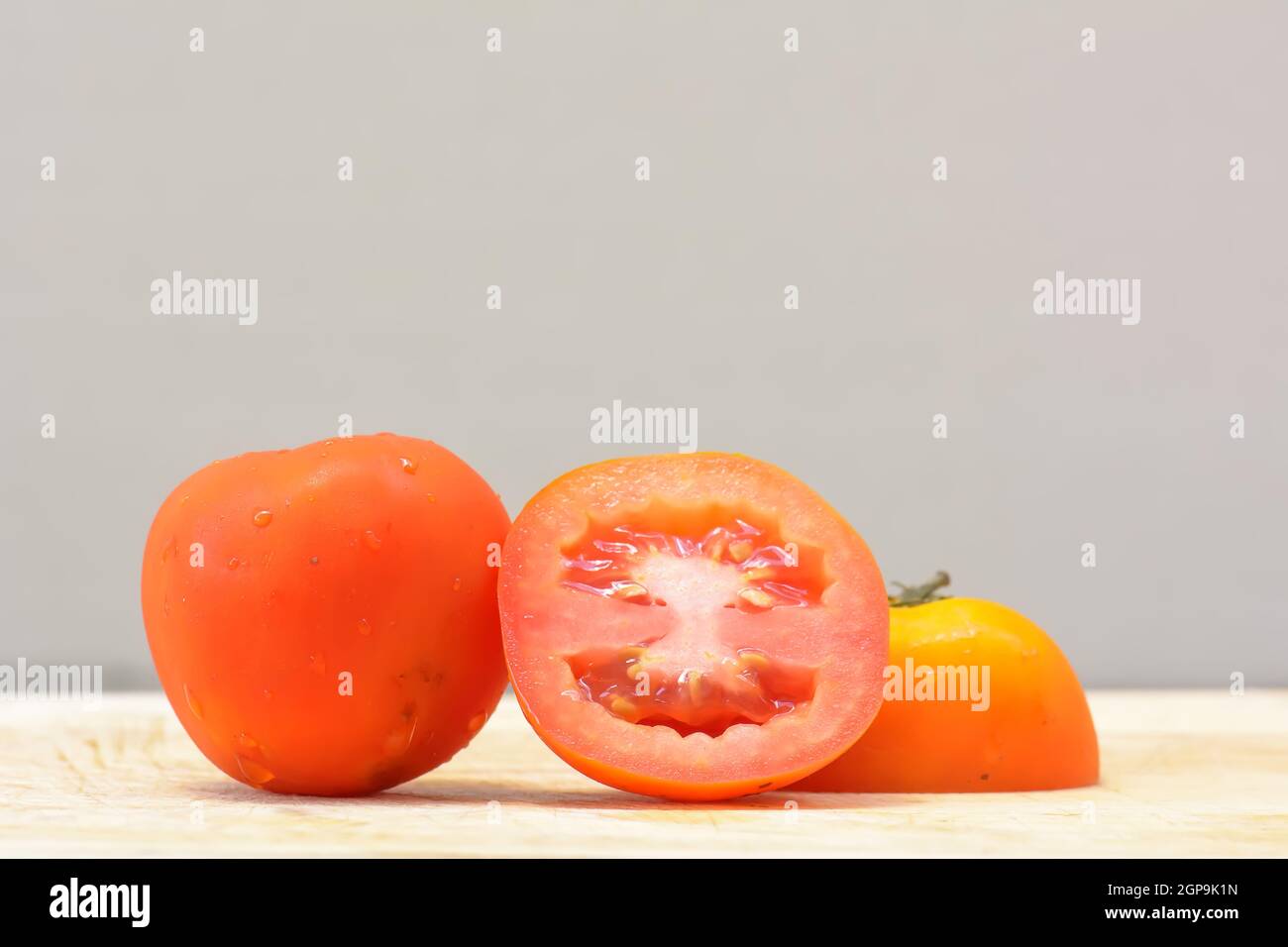 Close up tomato on the chopping board wood Stock Photo - Alamy