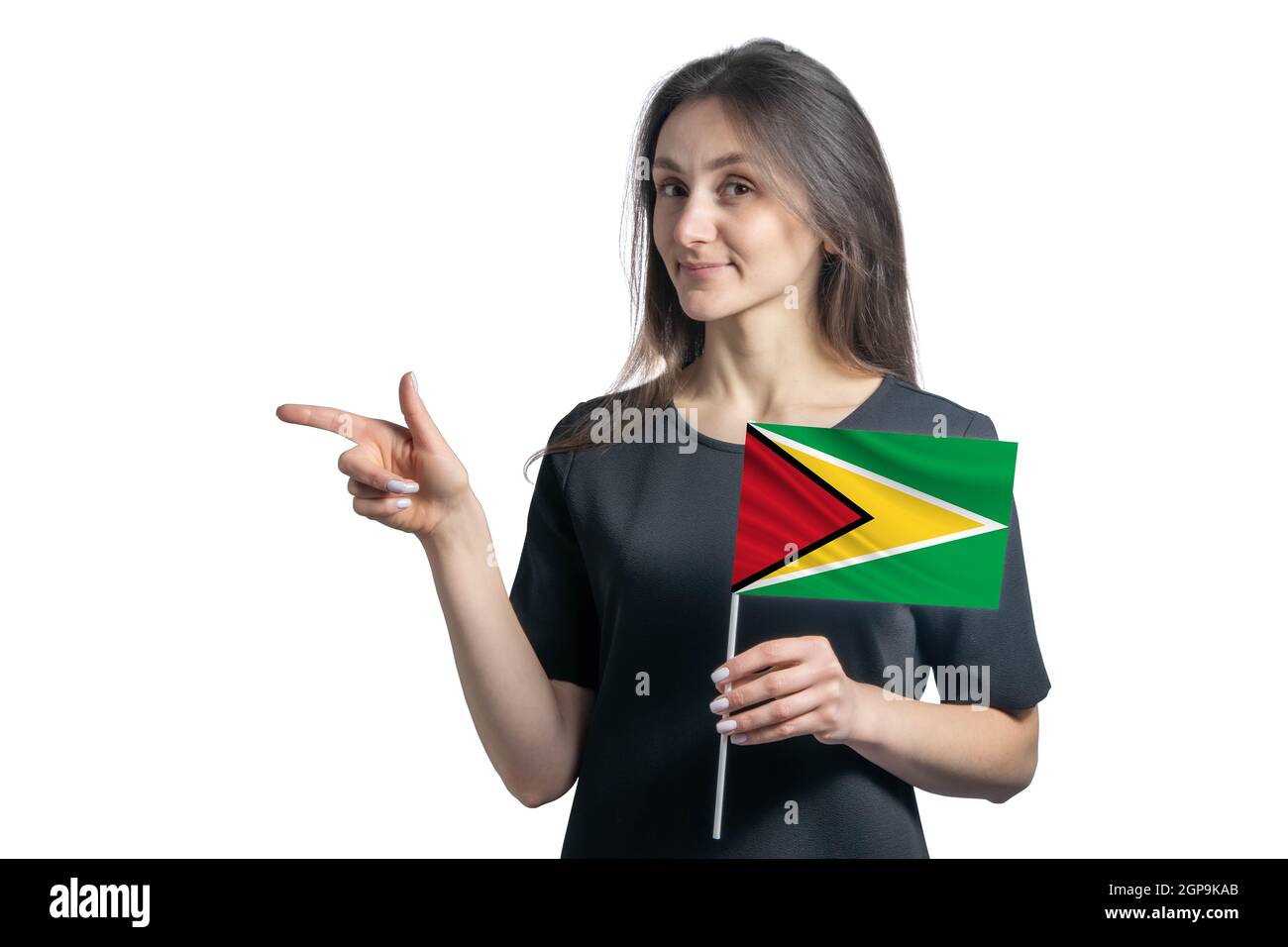 Happy young white woman holding flag Guyana and points to the left isolated on a white background. Stock Photo
