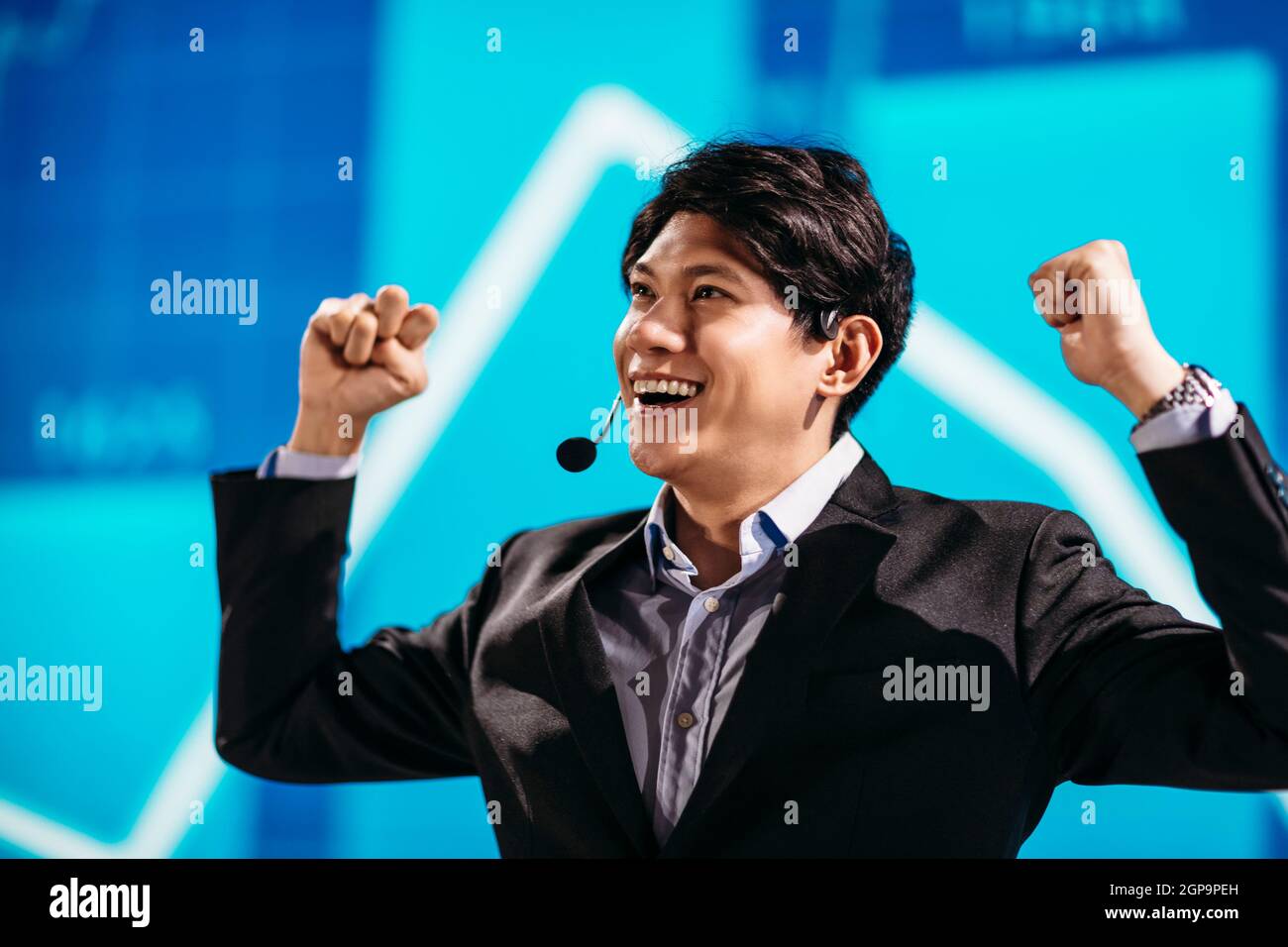 Asian Businessman Stands on Stage for Business Presentation Stock Photo