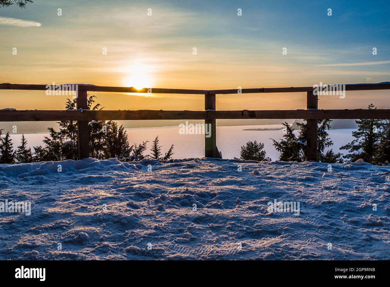 Winter Scene with Golden Sunset over Frozen Lake Stock Photo - Alamy