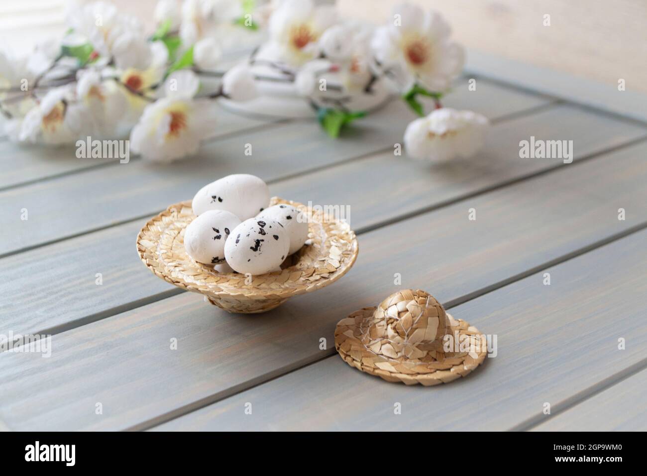 Straw hat decorated for easter with flowers and easter eggs for spring decoration Stock Photo