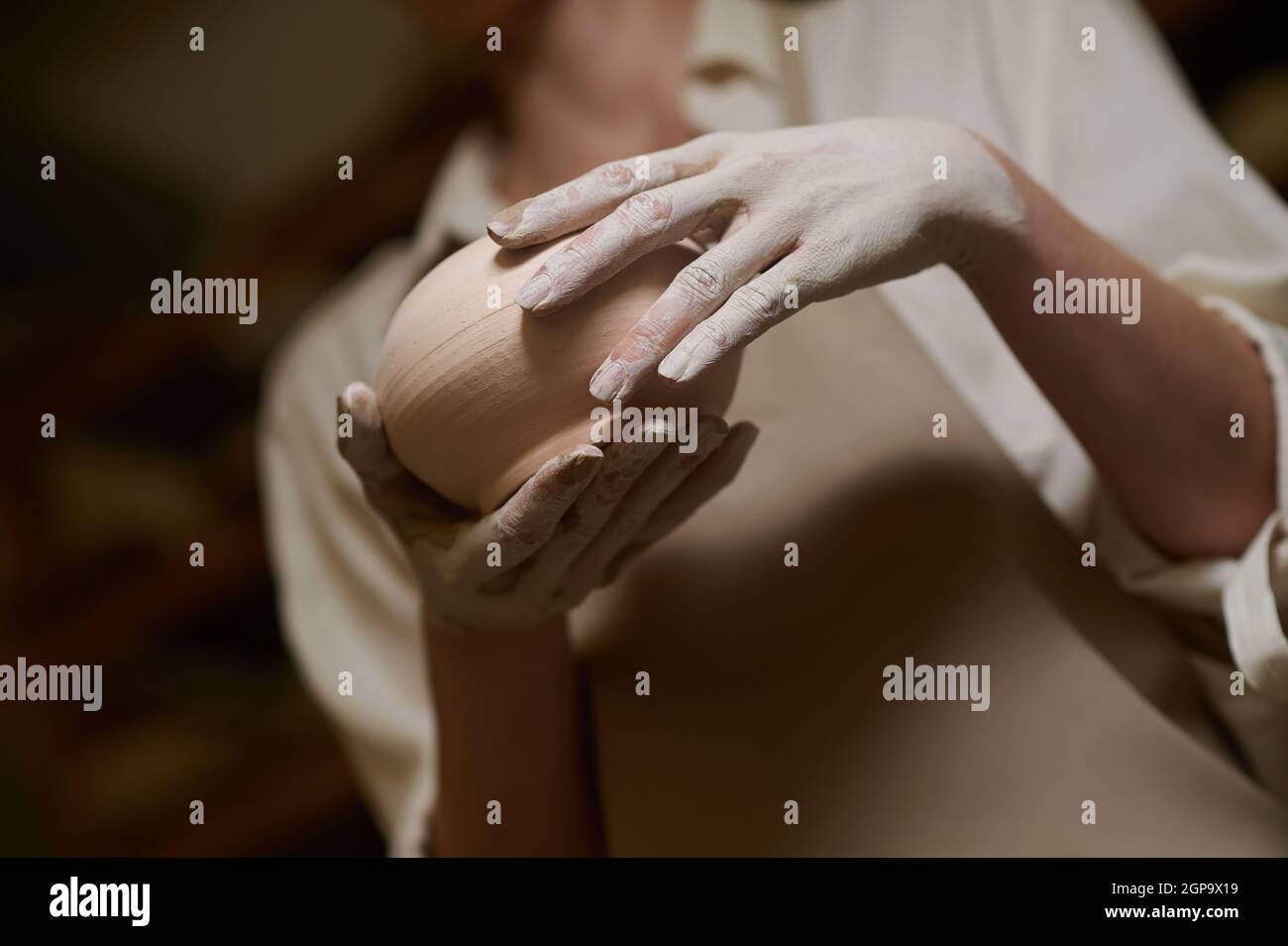 Close up of potters hands in clay and with a new bowl Stock Photo - Alamy