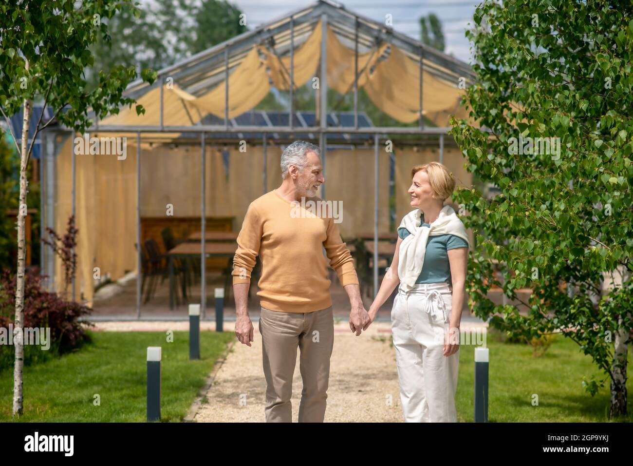 Loving husband and his joyful wife standing outdoors Stock Photo
