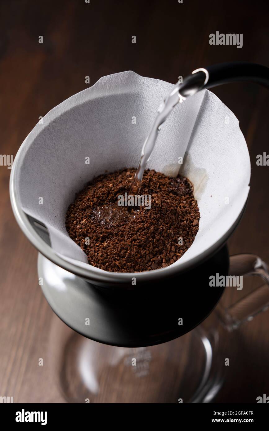 Pour hot water over the coffee powder. Make drip coffee Stock Photo Alamy