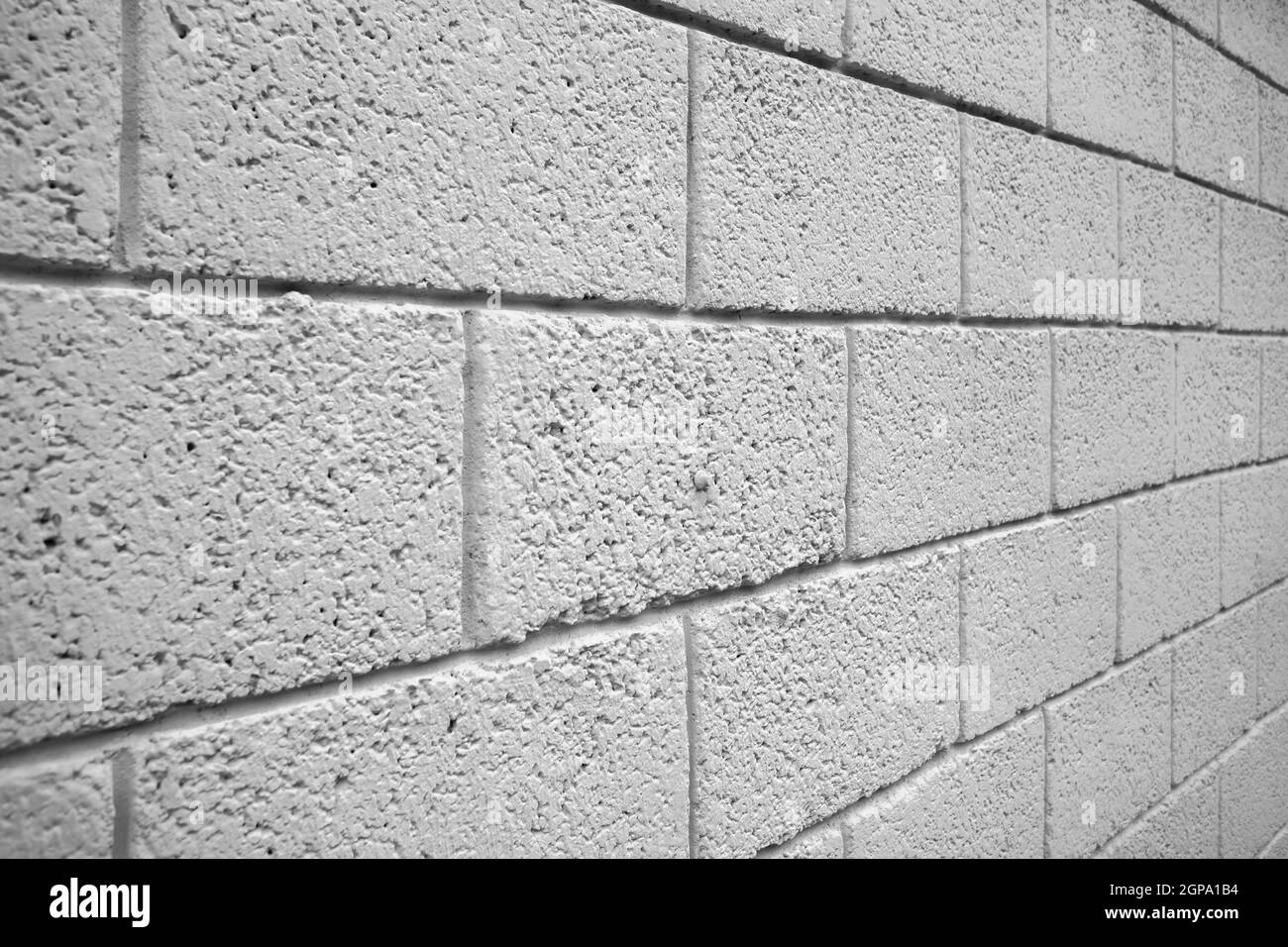 White brick block wall taken in an oblique corner. It can be used as