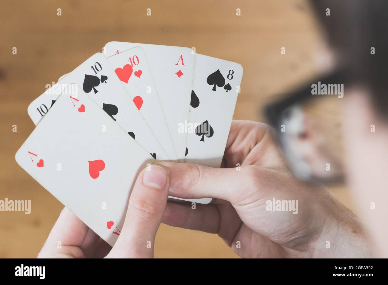 Man is playing cards, cutout of his hands Stock Photo Alamy