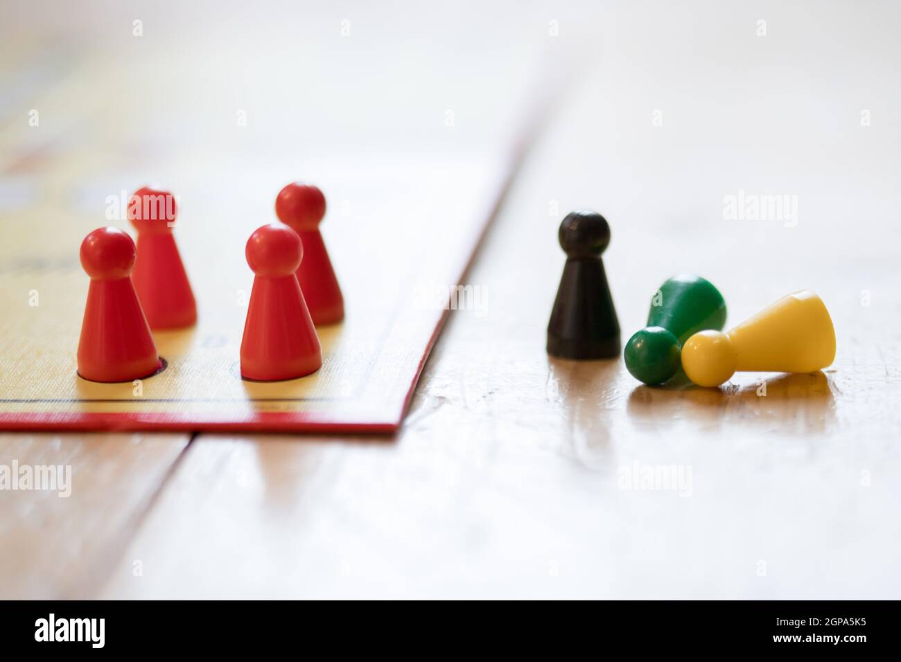 Meeples on a board, ready for playing a parlor game, ludo Stock Photo