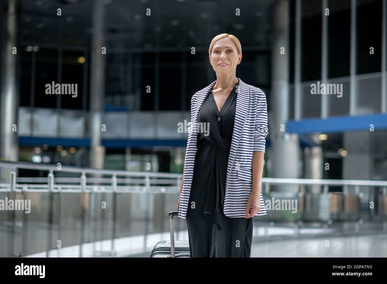 Woman smiling walking airport hi-res stock photography and images - Alamy