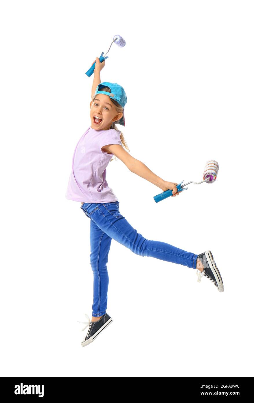 Little girl with paint rollers jumping on white background Stock Photo