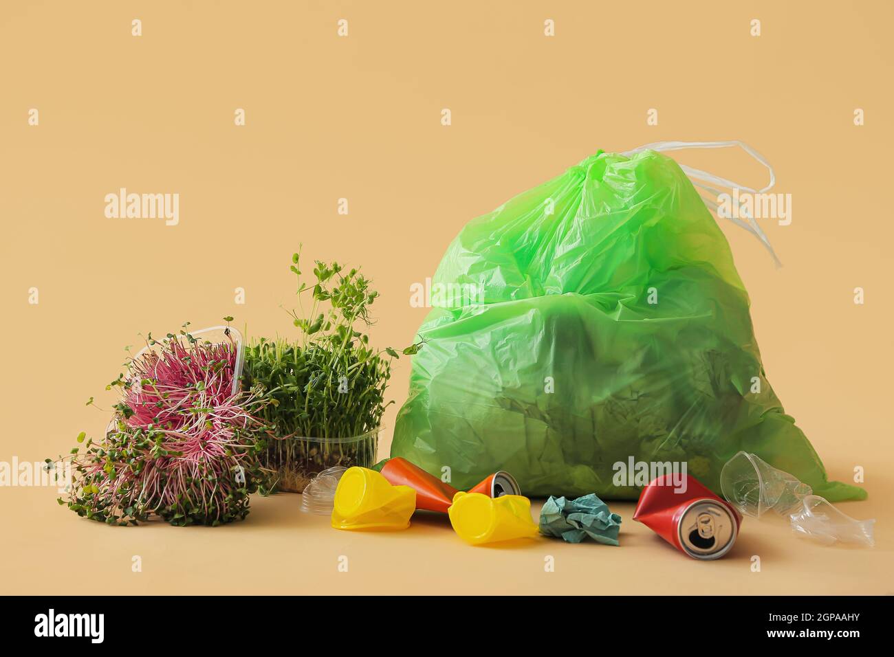 Micro Garbage Bag with different garbage and micro green on color background Stock ...