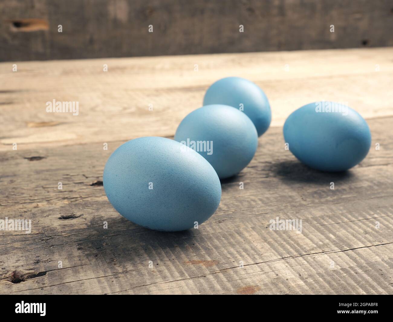 Naturally colored organic eggs on a rustic table with space for text, Easter background Stock Photo