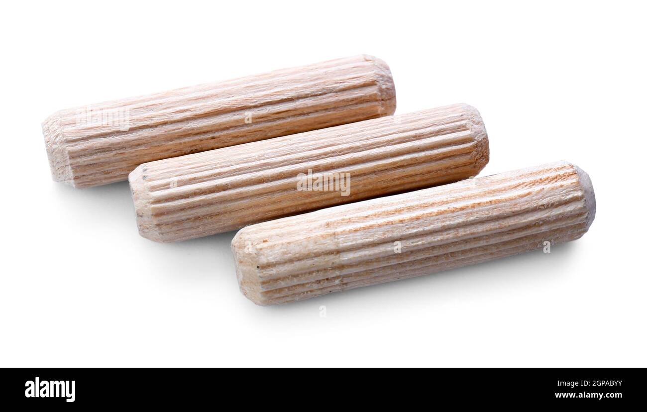 Wooden dowel pins on white background Stock Photo