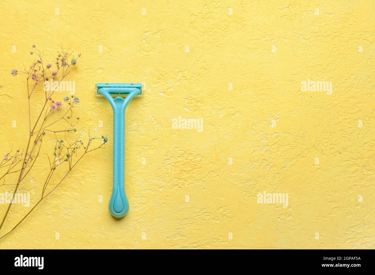 Safety razor on yellow background Stock Photo - Alamy