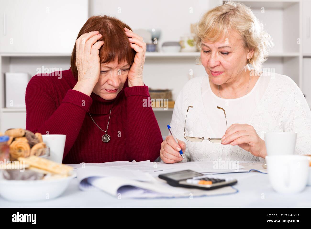 pensioners females with utilities bills Stock Photo