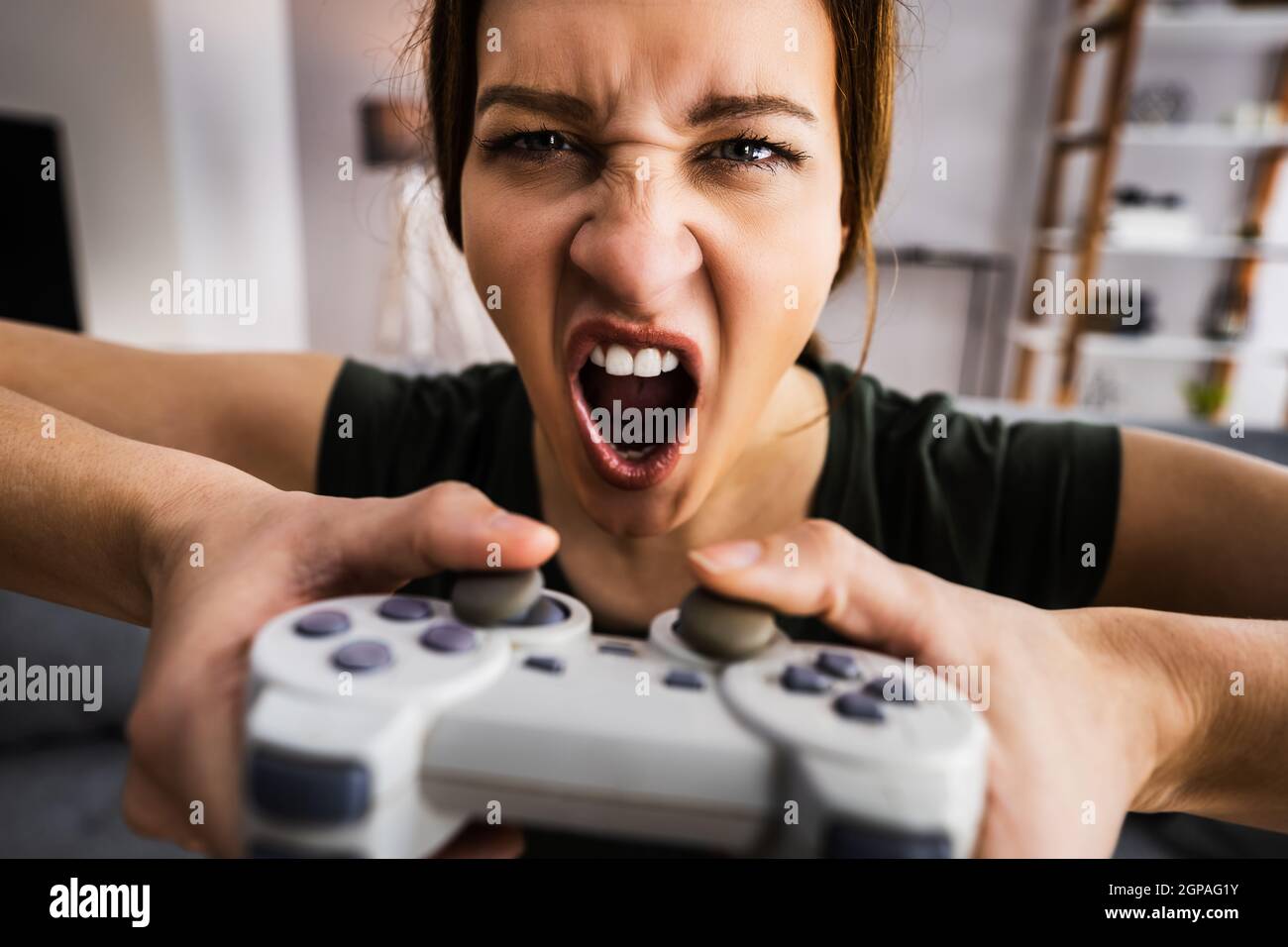 Female Gaming Addiction. Player With Console Controller Stock Photo