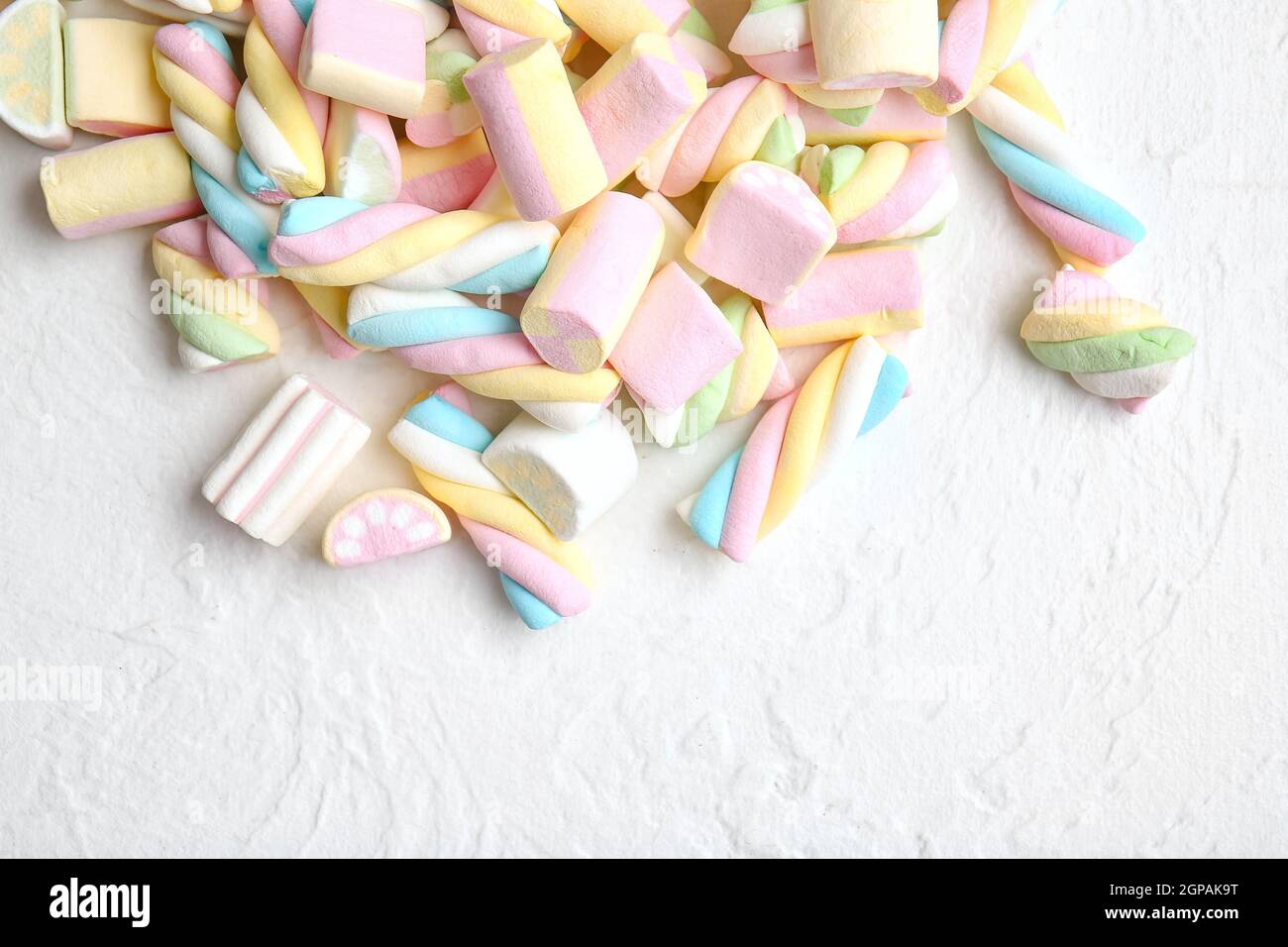 Tasty fluffy marshmallows on white background Stock Photo - Alamy