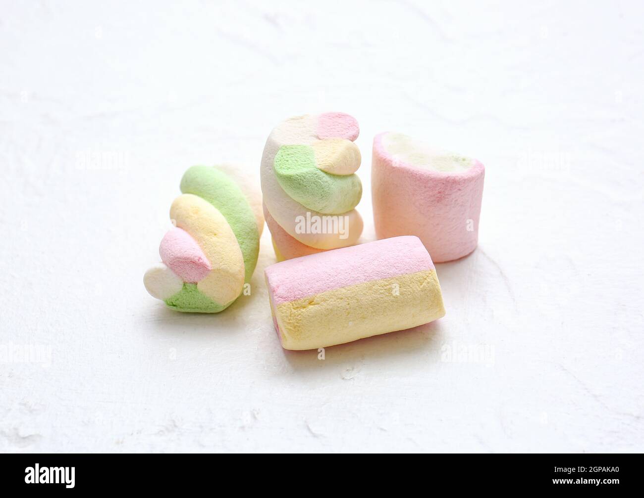 Different tasty marshmallows on white background Stock Photo - Alamy