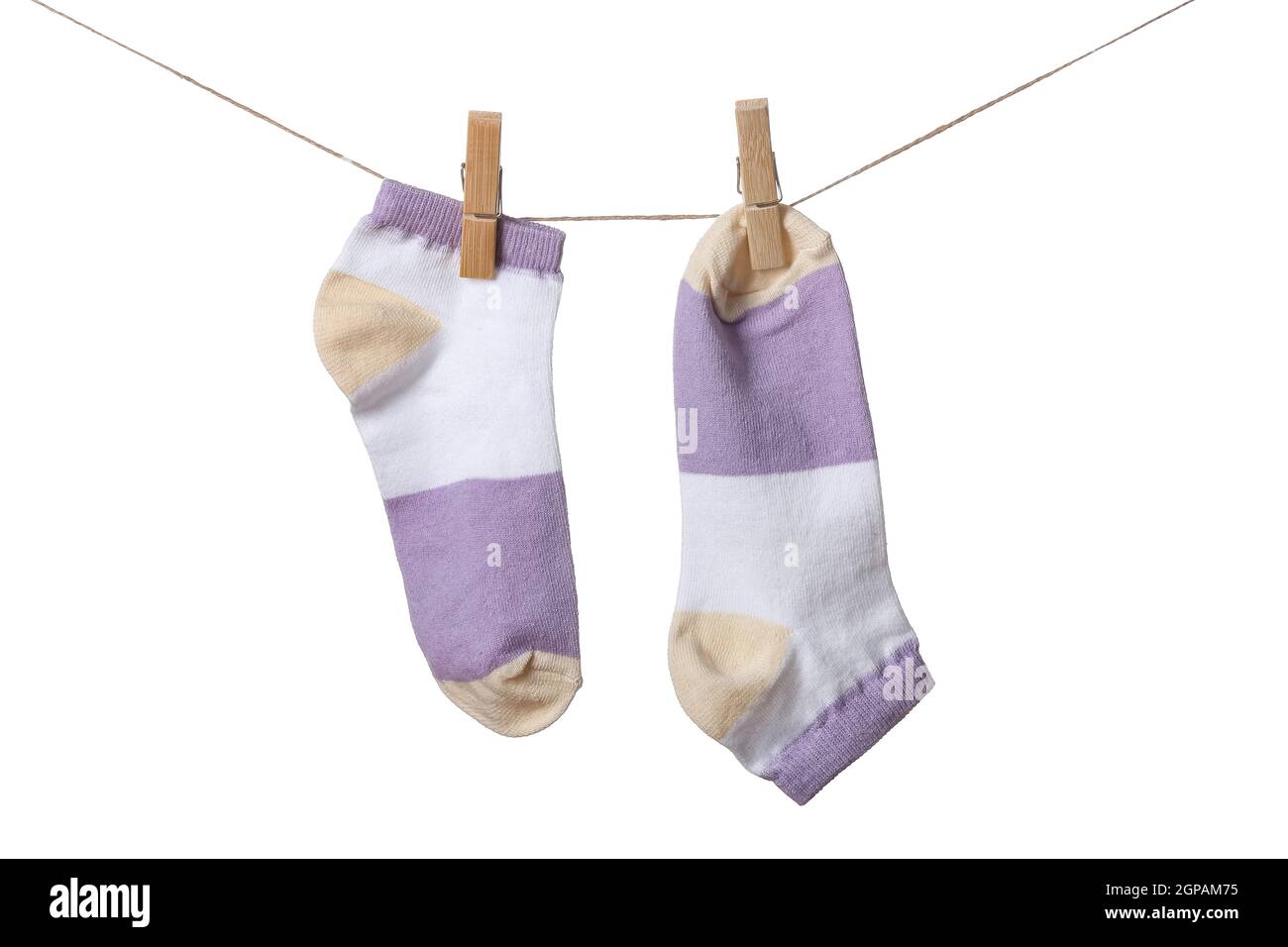 Pair of socks hanging on rope against white background Stock Photo - Alamy