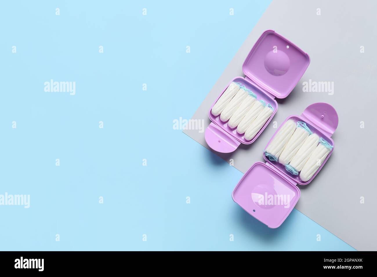 Tampons storage boxes on blue and grey background Stock Photo Alamy