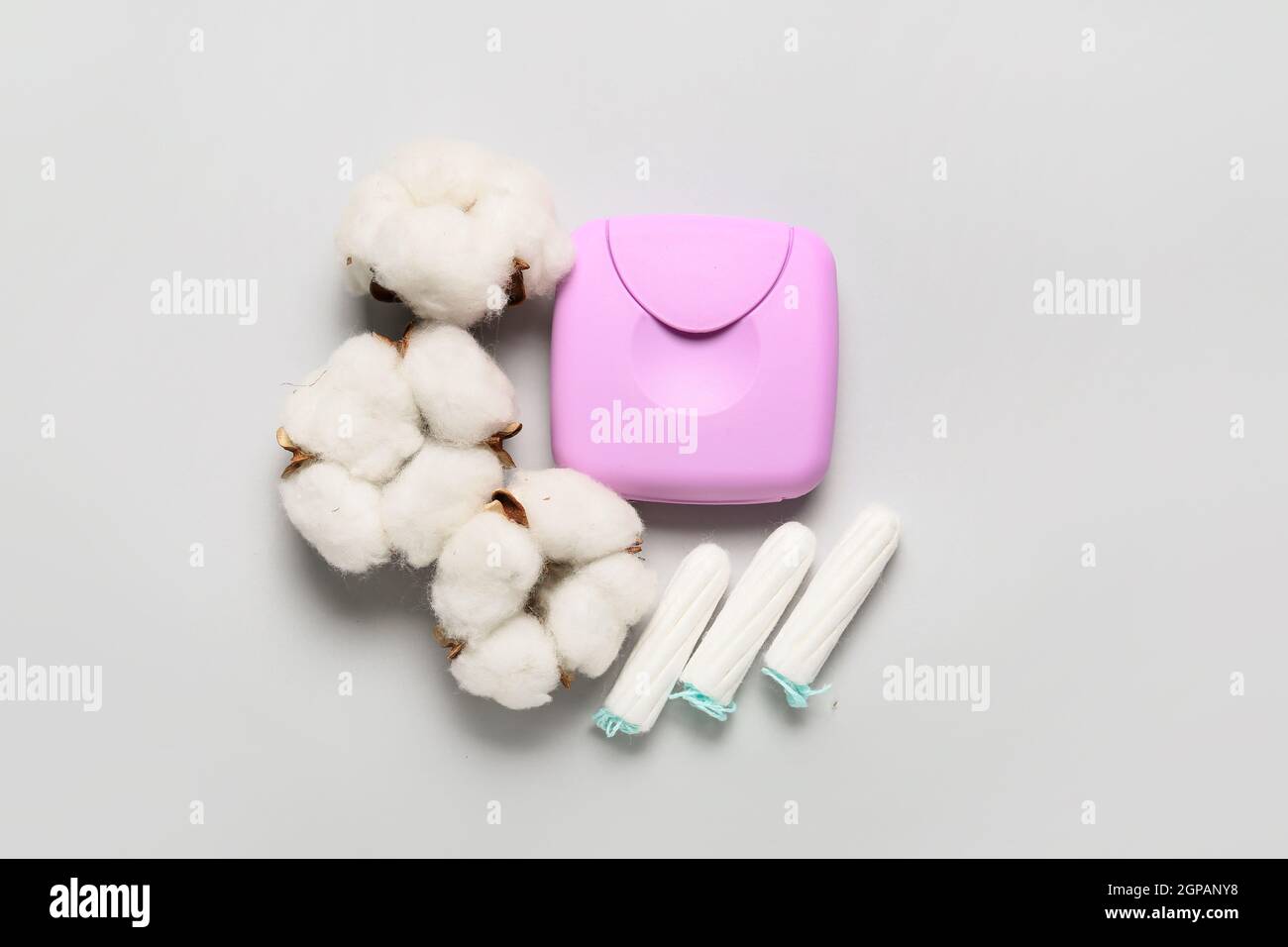 Plastic box for storing women's tampons with cotton flowers on grey