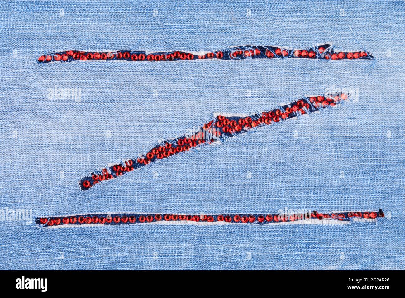 Fashionable background, jeans and red rhinestones, with space for your