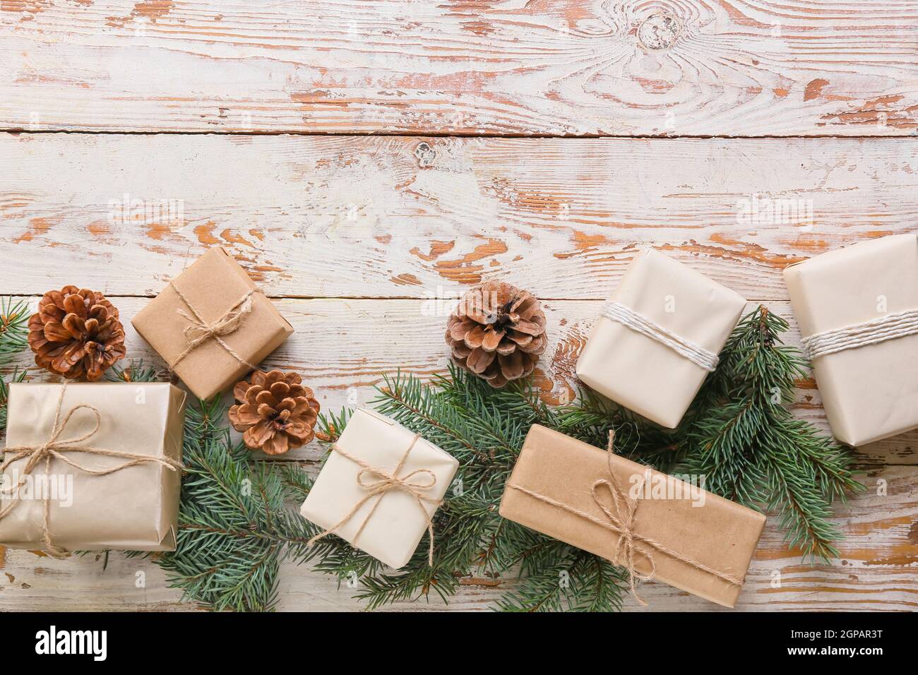 Christmas gifts with fir branches and cones on wooden background Stock ...