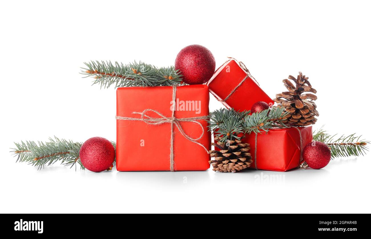 Christmas gifts with fir branches and cones on white background Stock ...