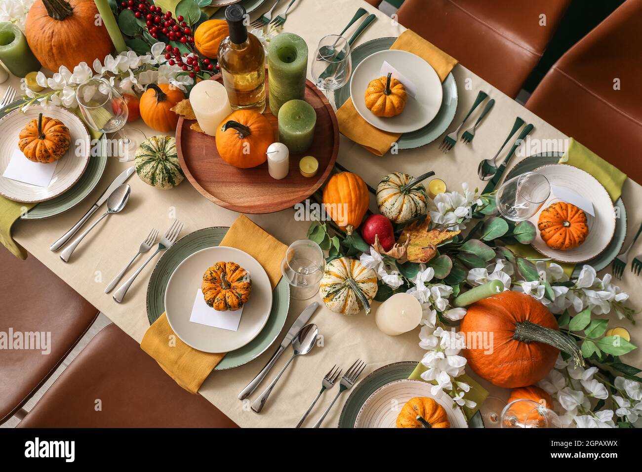 Autumn table setting with fresh pumpkins and flowers in room Stock ...