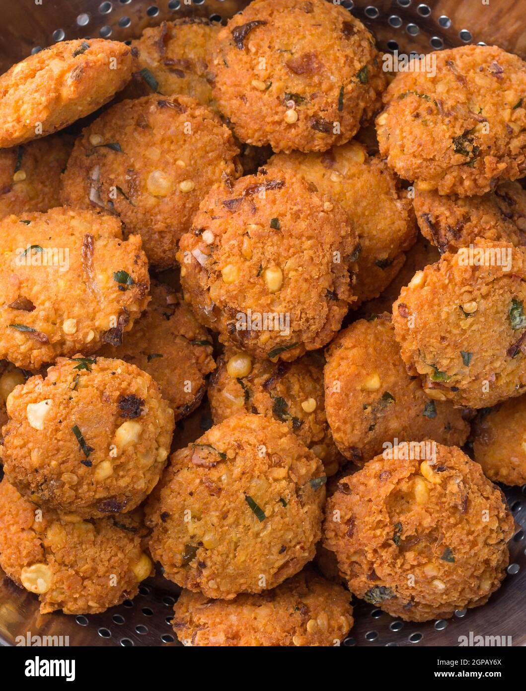 lentil fritters, savoury fried snack also called dal vada, wada or vadai in south east asia, deep fried vegetarian food Stock Photo