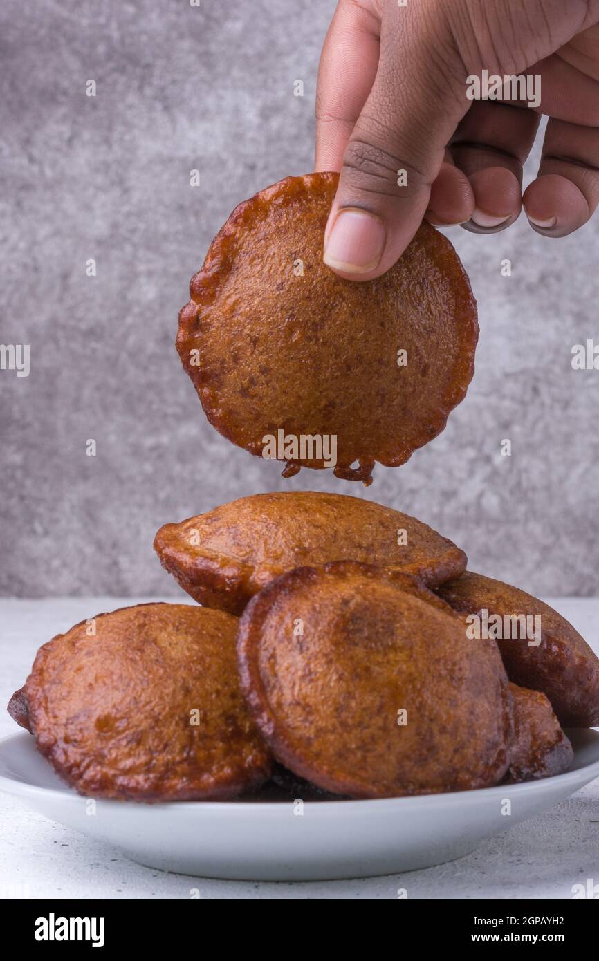 deep fried sri lankan sweet called kevum or kavum, served traditional dessert made from rice flour and palm sugar or kithul sugar Stock Photo