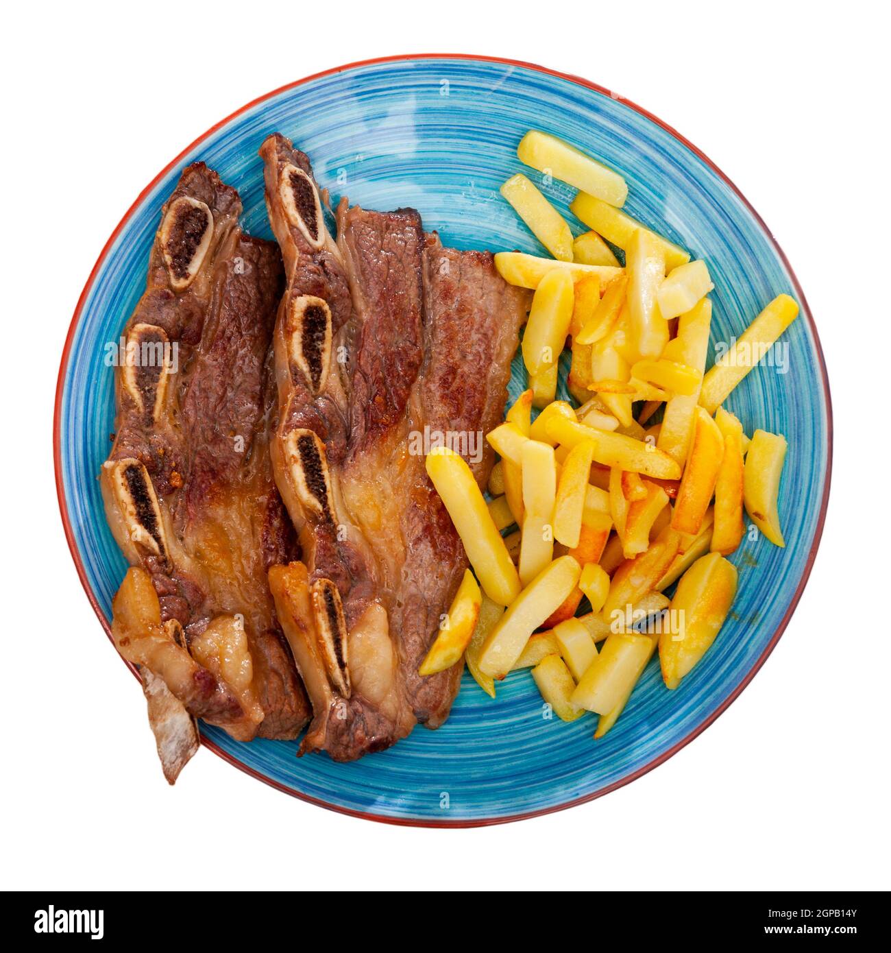 Grilled beef ribs with vegetable garnish of french fries Stock Photo