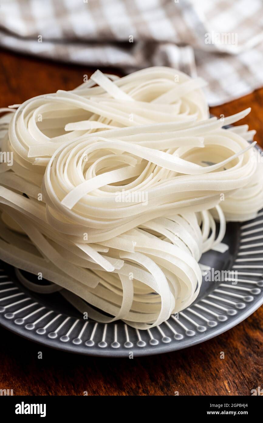 Dried white rice noodles. Raw pasta. Uncooked noodles on plate Stock Photo Alamy