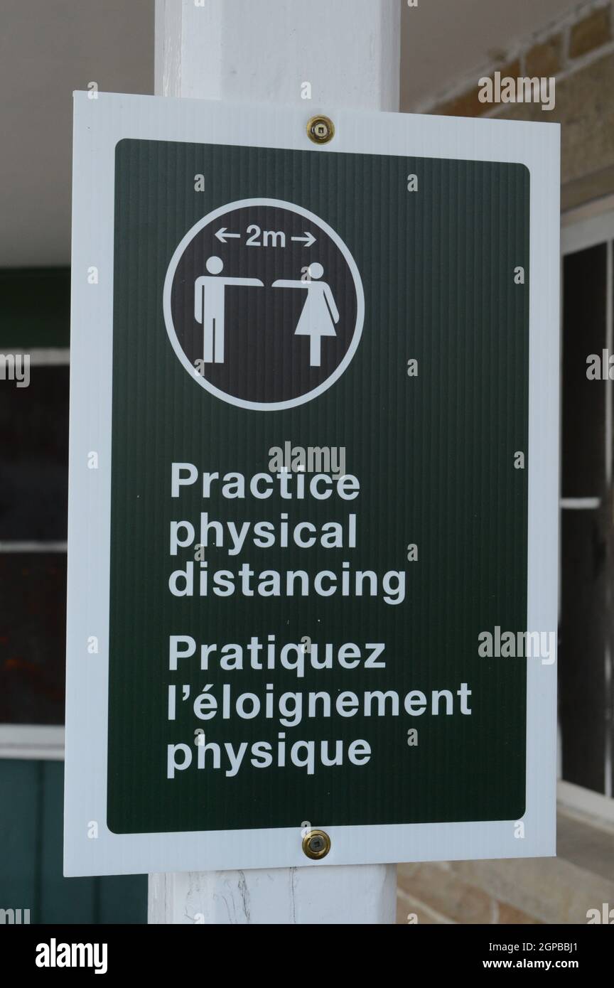 A closeup of a sign for informing the public about physical distancing practices. Stock Photo