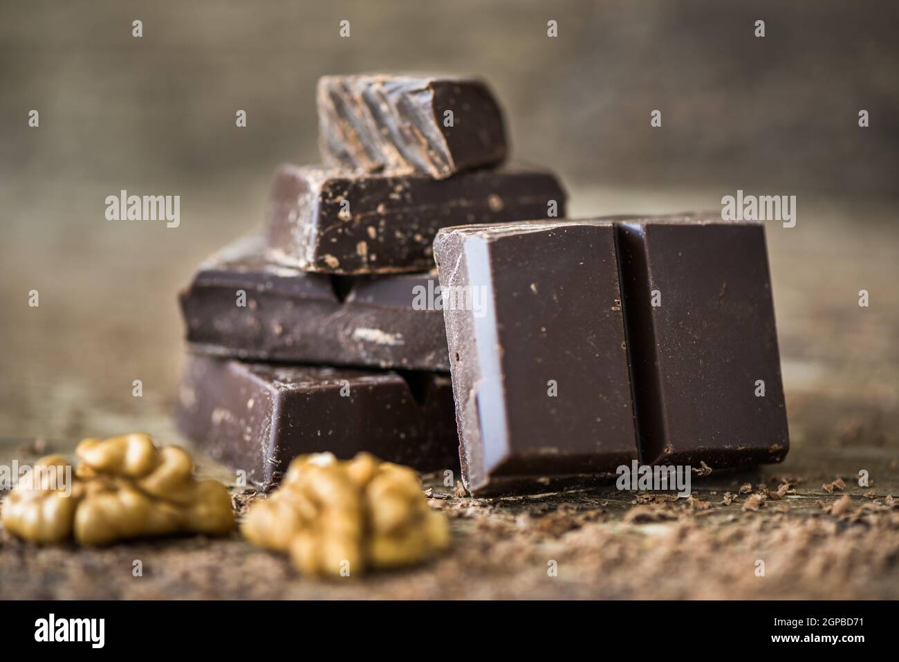 Dark Chocolate Pieces Stack on Rustic Background Stock Photo - Alamy