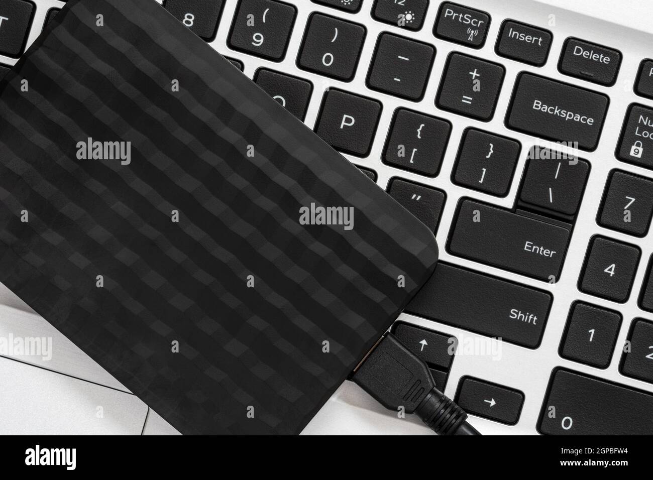 Backup data with external hard disk drive on computer keyboard Stock