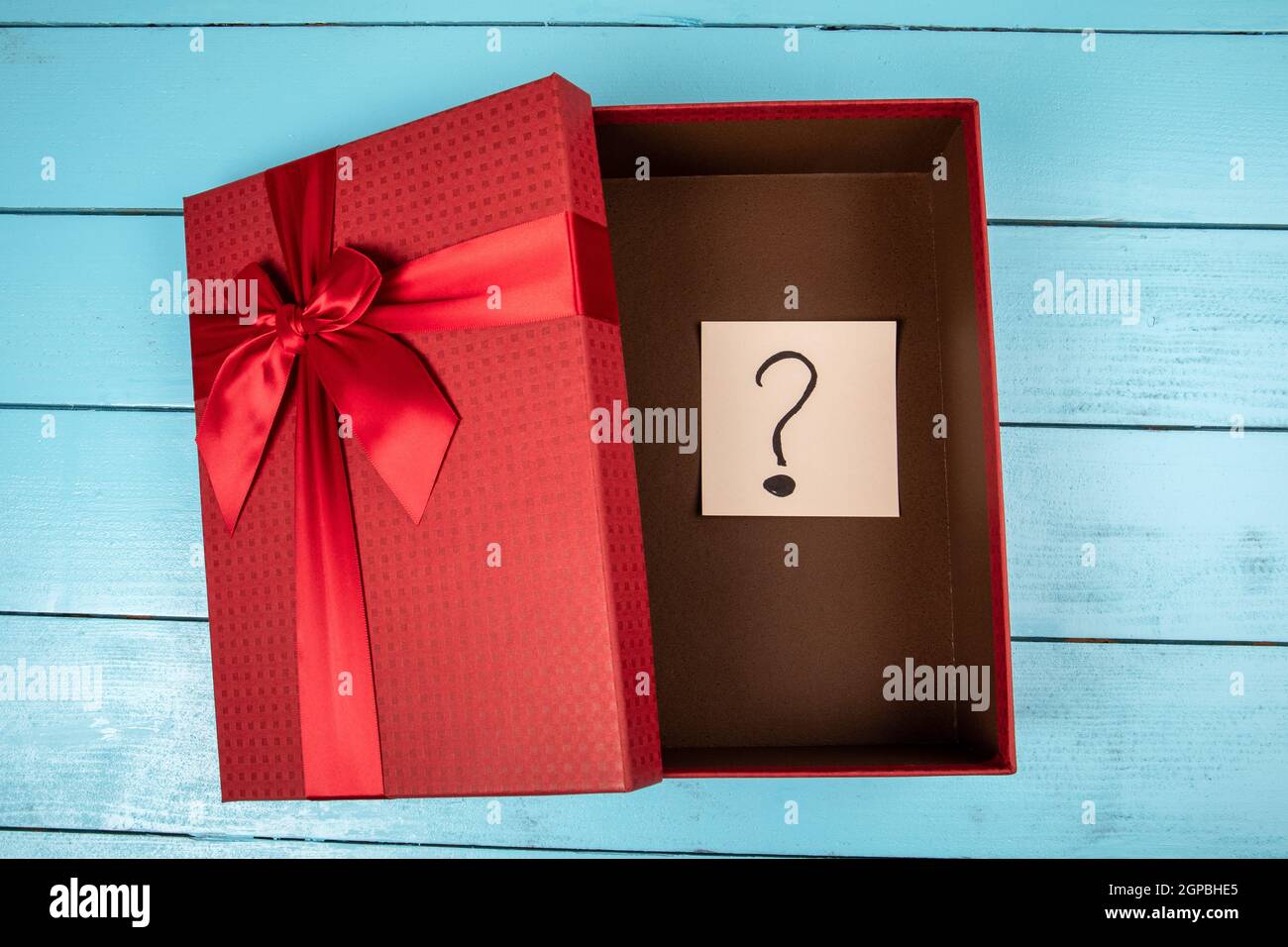Red gift box with a question mark inside. Christmas, birthday or ...