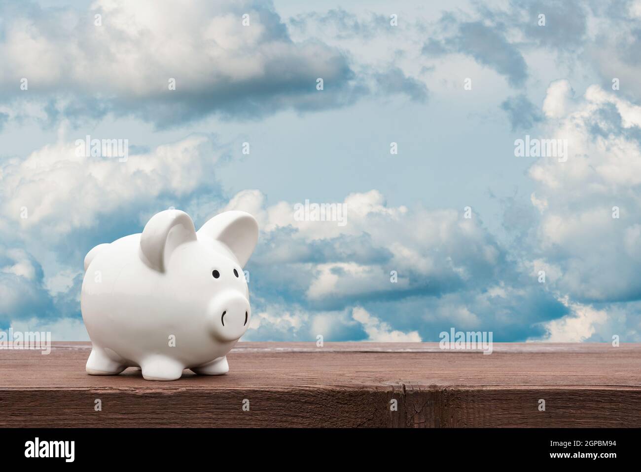 White piggy bank with sky background - business concept Stock Photo - Alamy