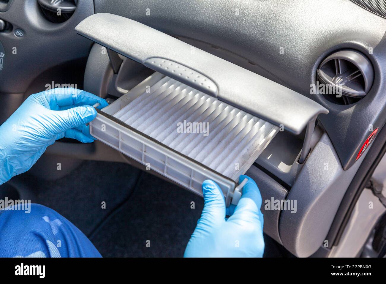 Replacing cabin pollen air filter for a car Stock Photo Alamy