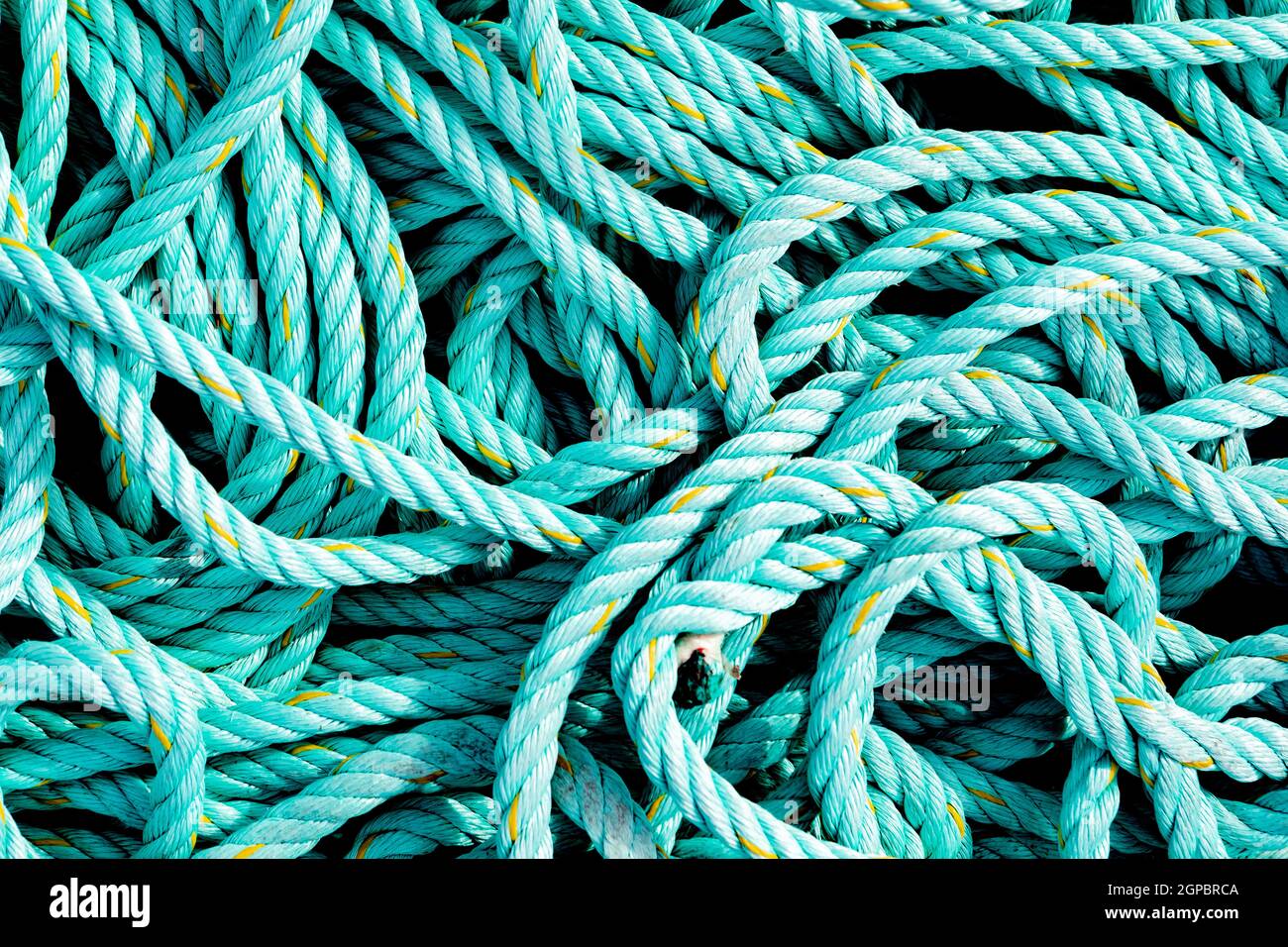 Tangled ropes of green color close up Stock Photo - Alamy