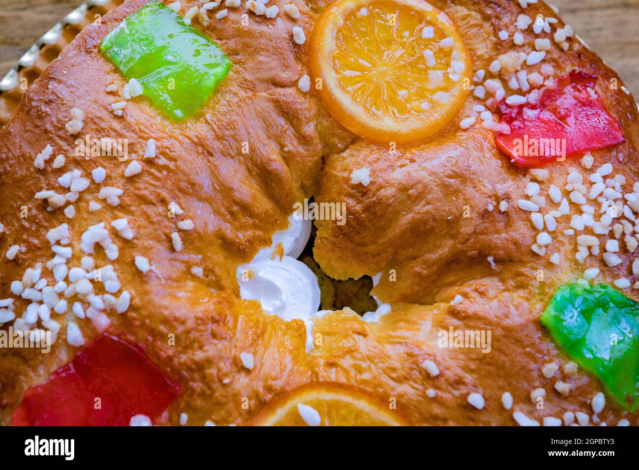 Christmas round fruit cake decorated with fir tree branch, glazed