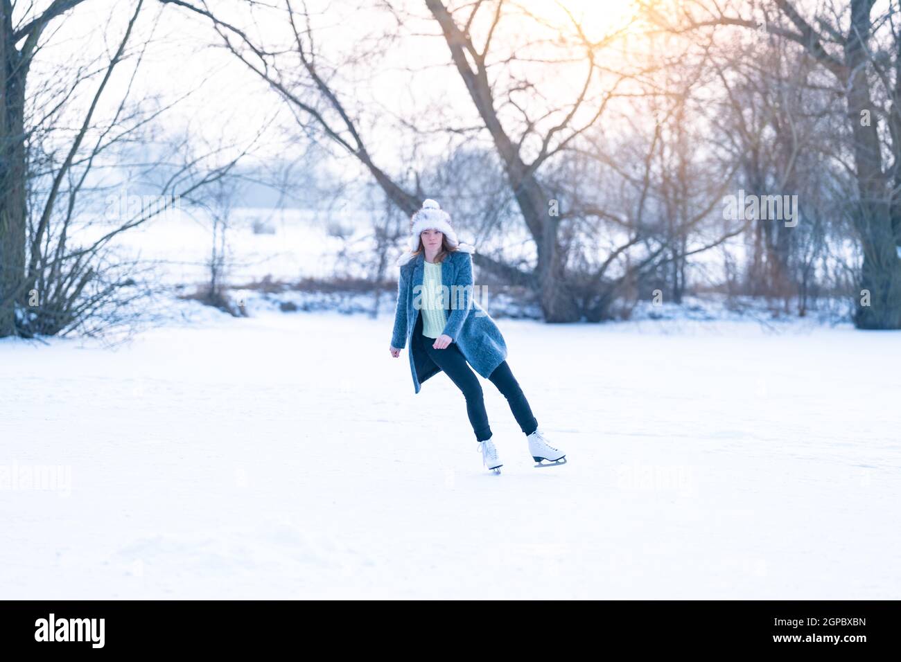 ice skating on the ice of a frozen lake young attractive woman Stock ...