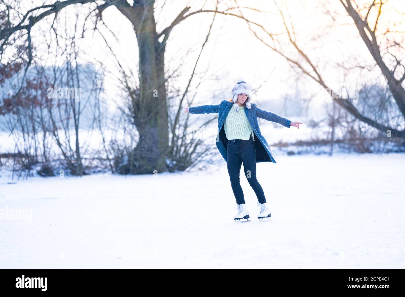 ice skating on the ice of a frozen lake young attractive woman Stock ...