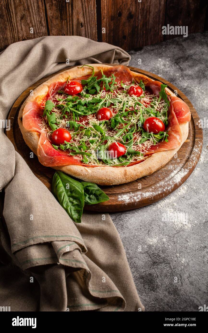 Italian Cuisine. Thin pizza with thick sides. Pizza in tomato sauce ...