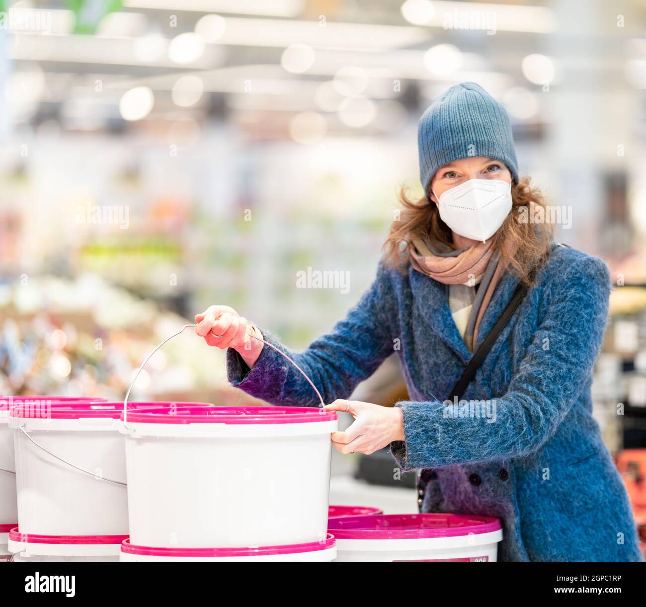 buying paint colors by young woman in the store Stock Photo Alamy