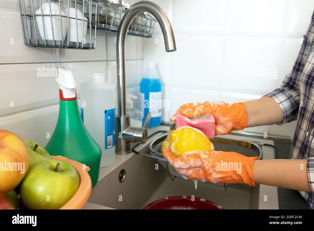 Washing fruits in the kitchen with water and soap Stock Photo Alamy