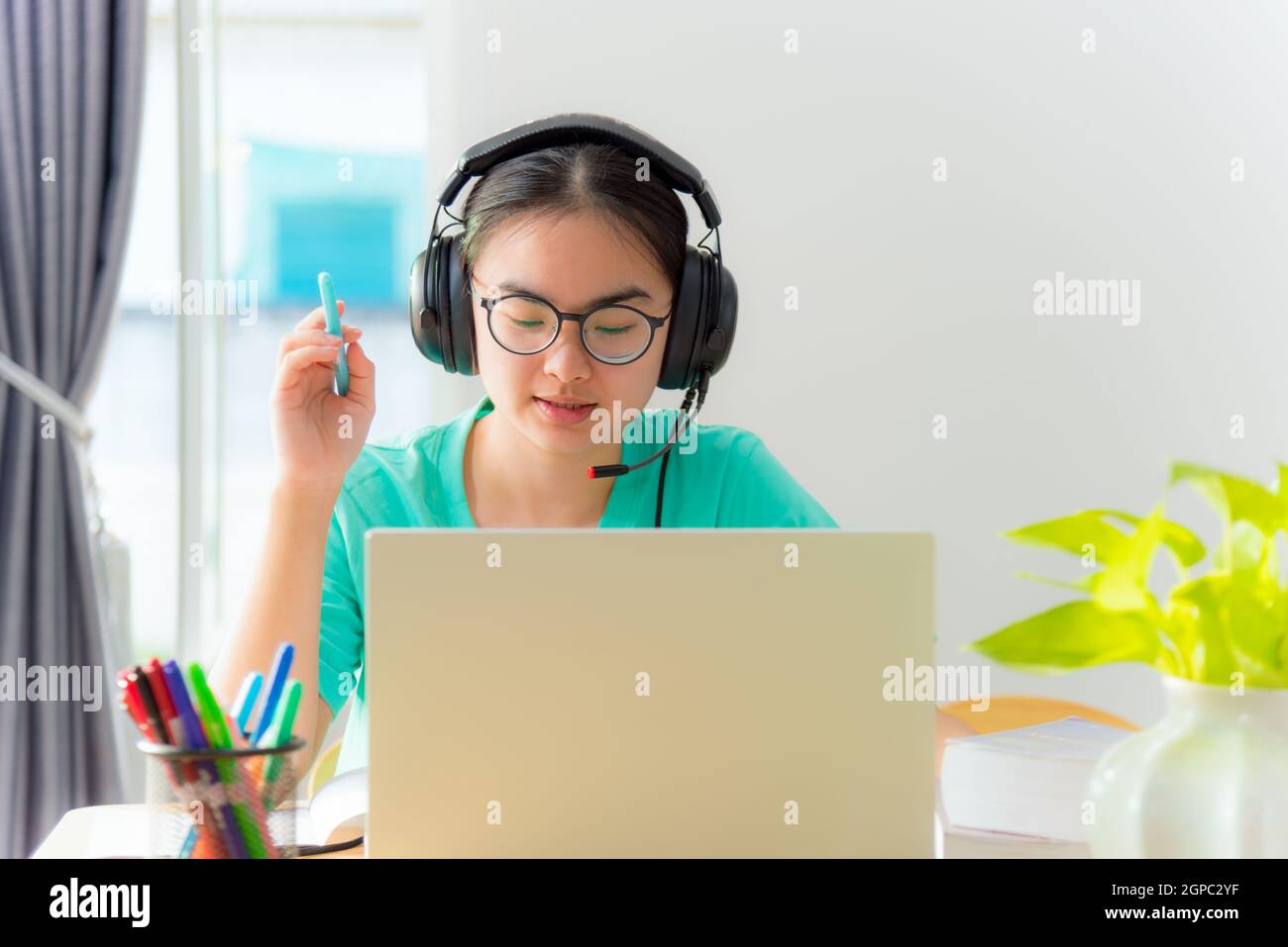 Asian young woman student with glasses headphones girl study serious ...