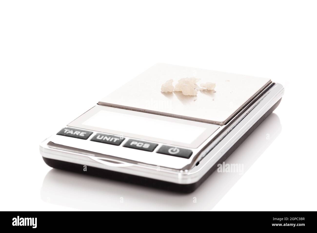 Pills of MDMA synthetic drugs on small digital scale Stock Photo
