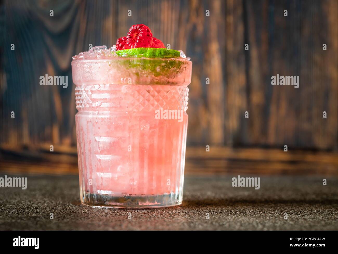 Glass of Knickerbocker cocktail made of rum, lime juice, orange curacao and raspberry syrup Stock Photo